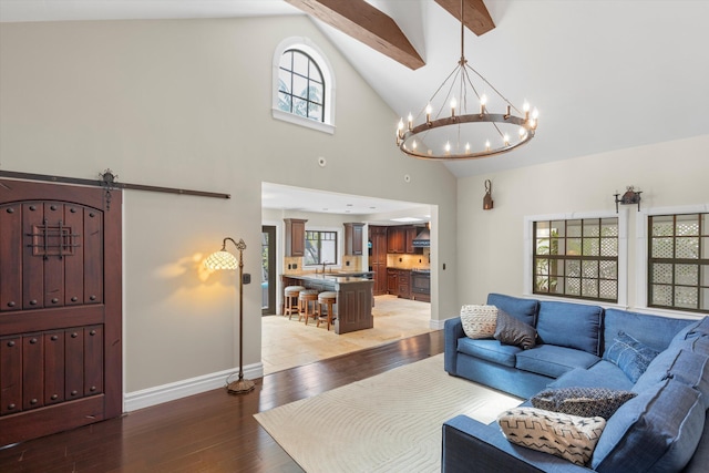 3532 Duck Ave, Key West, FL 33040 - living area featuring light wood-style floors, a chandelier, baseboards, and high vaulted ceiling