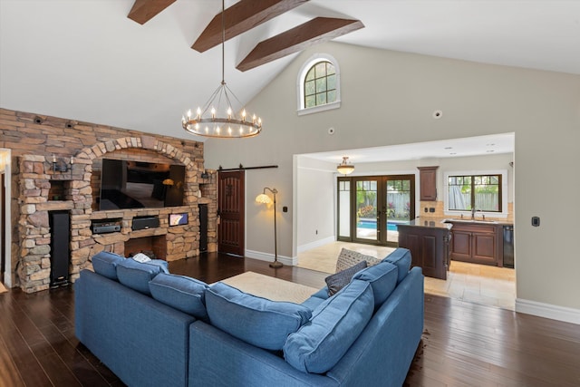 3532 Duck Ave, Key West, FL 33040 - living room with french doors, wood finished floors, a barn door, high vaulted ceiling, and baseboards
