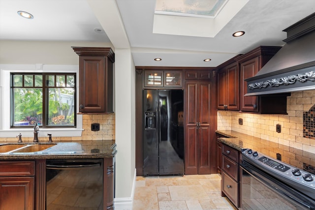 3532 Duck Ave, Key West, FL 33040 - kitchen featuring a sink, a skylight, dark stone countertops, black appliances, and stone tile floors