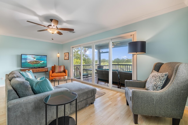 living room featuring ceiling fan, ornamental molding, and light hardwood / wood-style floors