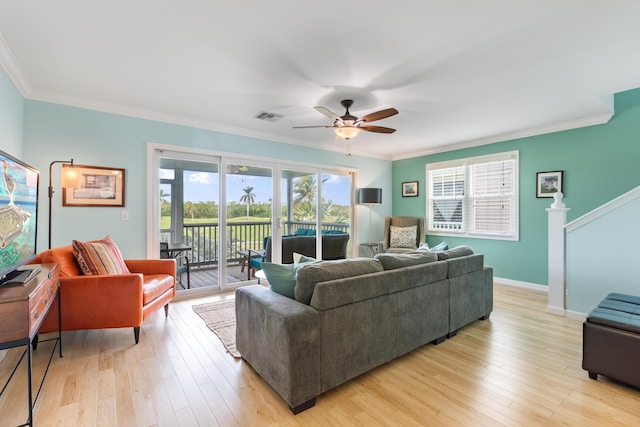 living room with ornamental molding, ceiling fan, and light wood-type flooring