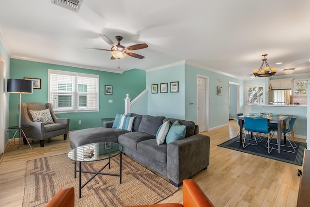 living room with crown molding, ceiling fan, and light wood-type flooring