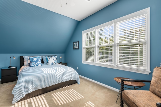 carpeted bedroom featuring lofted ceiling