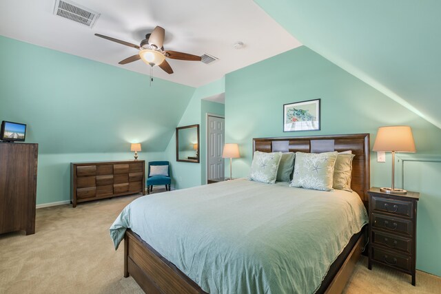 carpeted bedroom with ceiling fan and vaulted ceiling