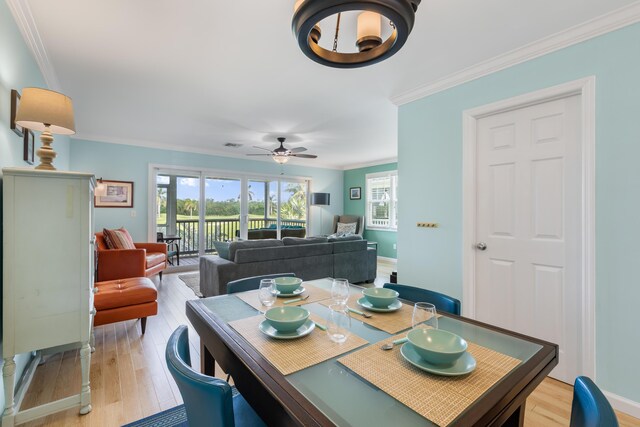 dining area with crown molding, ceiling fan, and light wood-type flooring