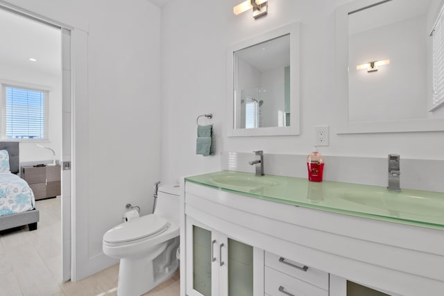 bathroom featuring vanity, tile patterned floors, and toilet