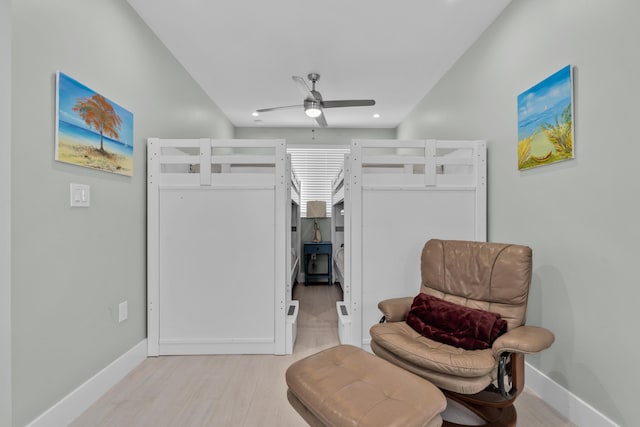 living area with ceiling fan and light hardwood / wood-style flooring