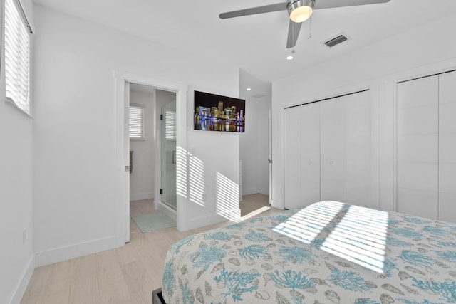 bedroom with multiple closets, ceiling fan, and light hardwood / wood-style floors