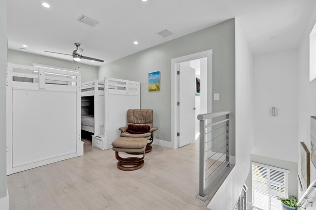 sitting room featuring ceiling fan and light wood-type flooring