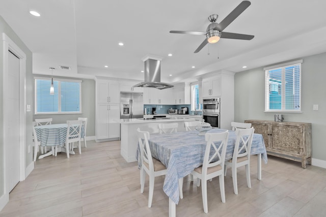 dining area featuring ceiling fan and light hardwood / wood-style floors