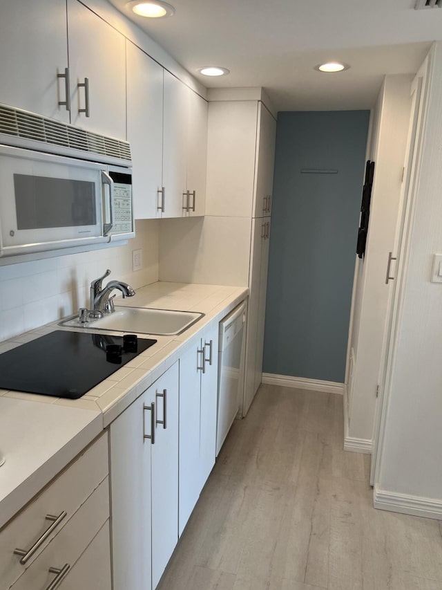 2000 Coco Plum Dr Unit 605, Marathon, FL 33050 - kitchen with white appliances, light wood-type flooring, white cabinetry, light countertops, and recessed lighting