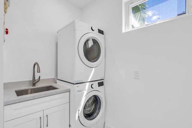 84 Coral Way -, Unit Key Largo, FL 33037 - laundry room featuring stacked washer / drying machine and cabinet space
