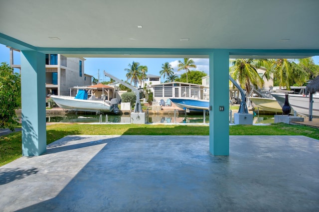 84 Coral Way -, Unit Key Largo, FL 33037 - view of patio featuring boat lift, a boat dock, and a water view