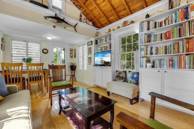 interior space with vaulted ceiling with beams, light hardwood / wood-style flooring, and wooden ceiling