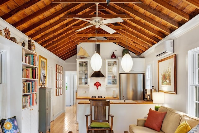 kitchen featuring wood ceiling, a wall mounted air conditioner, stainless steel refrigerator, gas cooktop, and pendant lighting