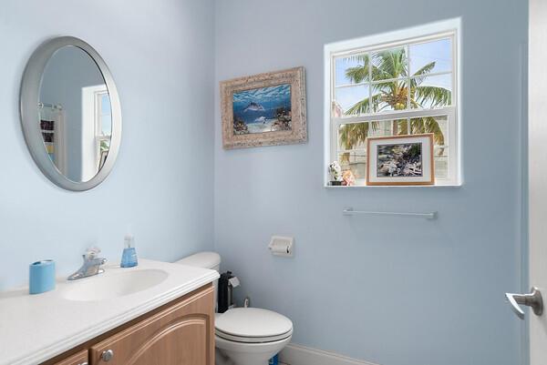 full bathroom with toilet, baseboards, and vanity