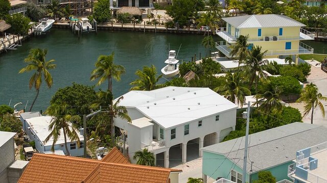 drone / aerial view with a residential view and a water view