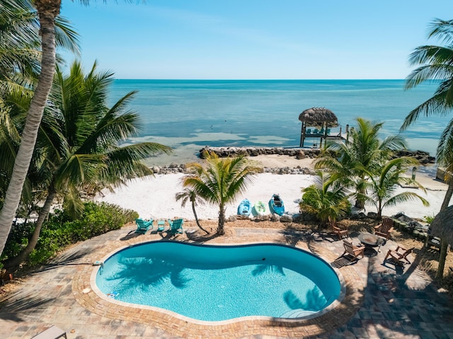 view of swimming pool with a water view