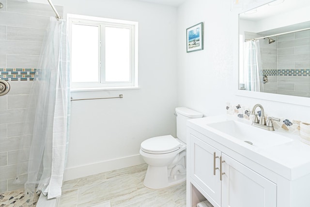 bathroom featuring vanity, toilet, and curtained shower