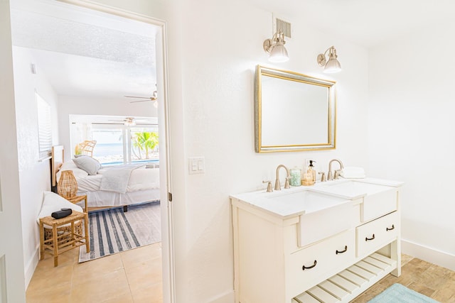 bathroom featuring tile patterned flooring, vanity, a textured ceiling, and ceiling fan