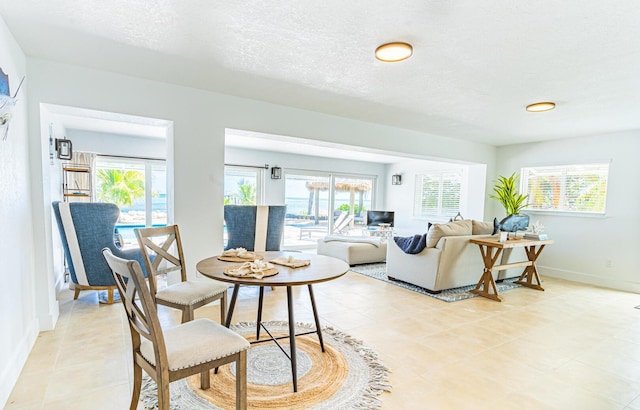 dining space with a textured ceiling