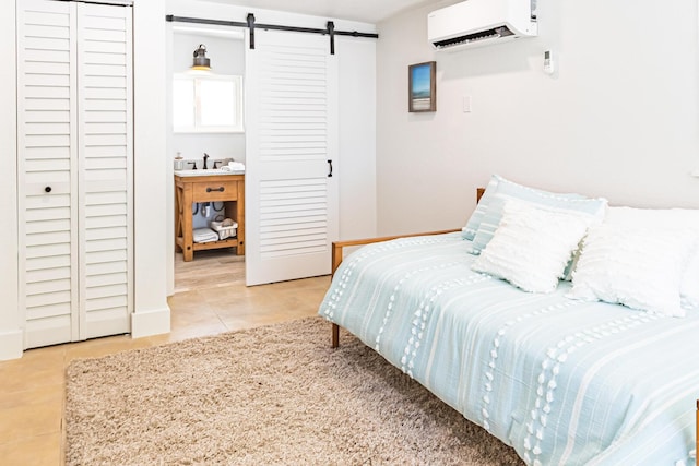 tiled bedroom featuring a barn door and an AC wall unit