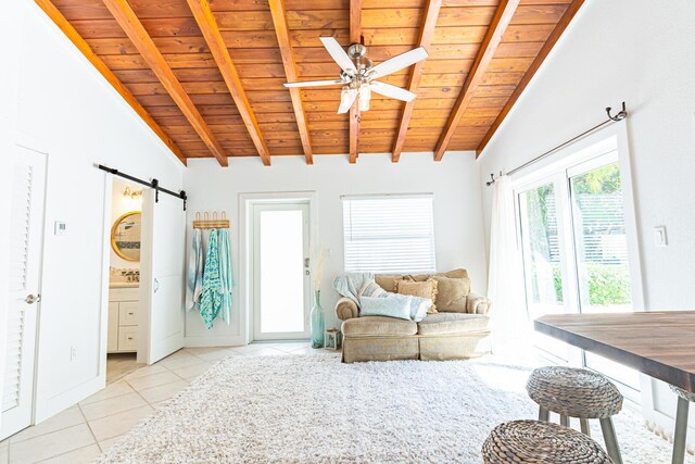 tiled living room with wooden ceiling, lofted ceiling with beams, a barn door, and ceiling fan