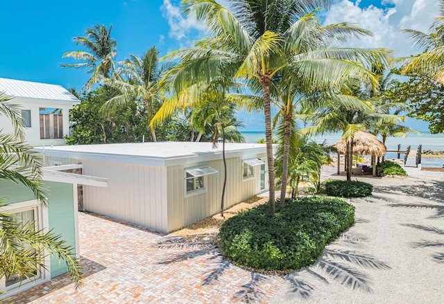 view of property exterior featuring a water view