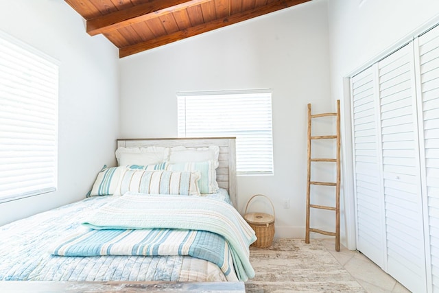 bedroom featuring light carpet, lofted ceiling with beams, and wooden ceiling