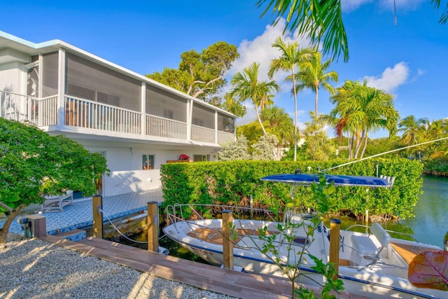 exterior space featuring a dock and a water view