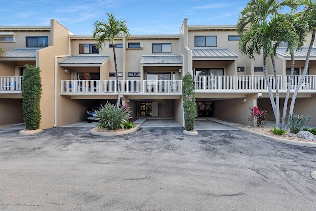 view of building exterior with driveway and a carport