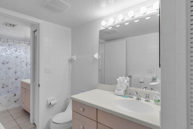 bathroom featuring toilet, visible vents, vanity, and tile patterned floors