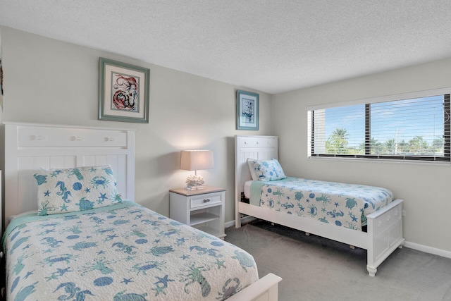 carpeted bedroom with baseboards and a textured ceiling