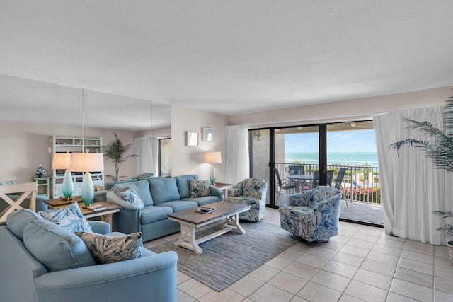 living room with a water view and light tile patterned floors