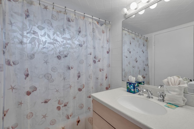 bathroom featuring vanity and a shower with shower curtain