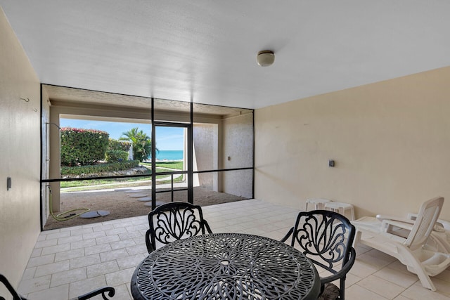 dining area with a sunroom and light tile patterned flooring