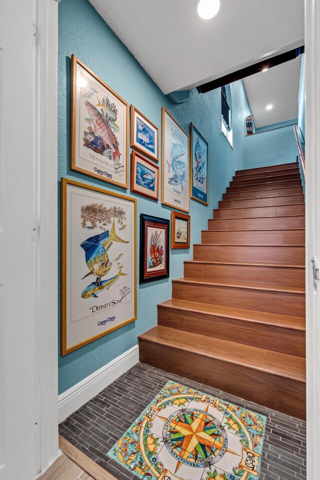 stairs with hardwood / wood-style flooring