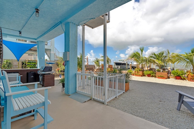 view of patio with grilling area and a jacuzzi