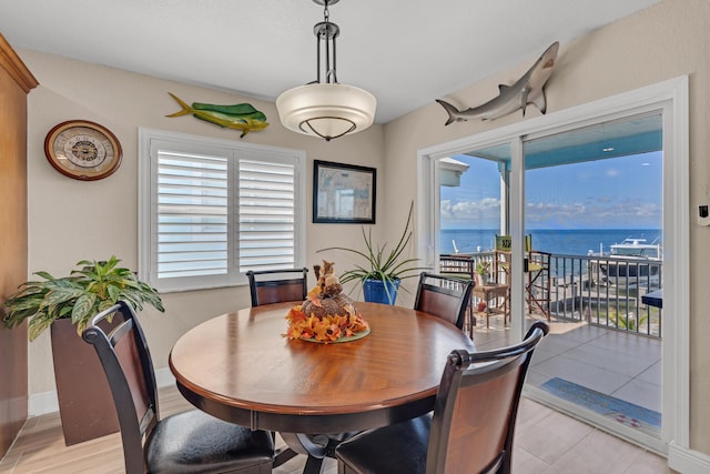 dining room with plenty of natural light and a water view