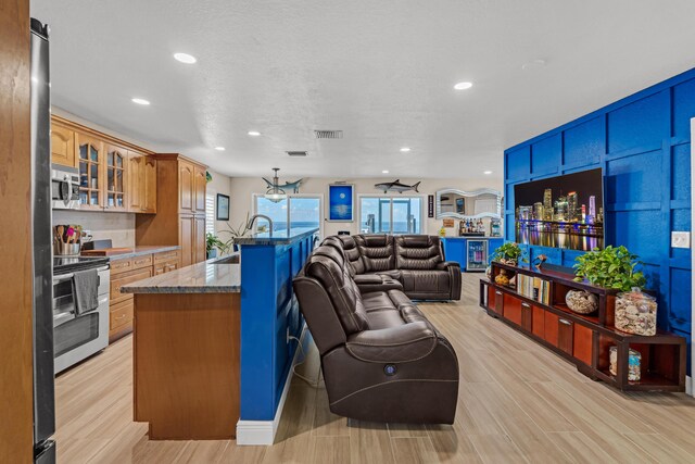 living room featuring light hardwood / wood-style floors and a textured ceiling