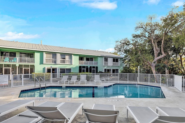 pool featuring a patio area and fence