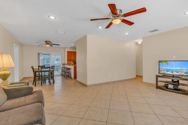 tiled living room with ceiling fan