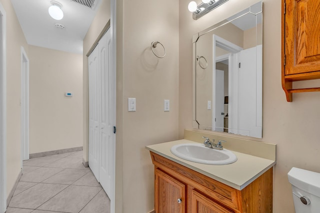 bathroom with vanity, tile patterned floors, and toilet