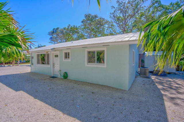 ranch-style house with cooling unit