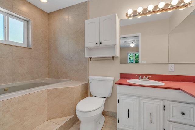 bathroom with vanity, a relaxing tiled tub, a wealth of natural light, and toilet