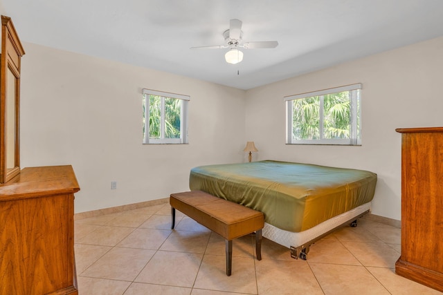 tiled bedroom featuring ceiling fan