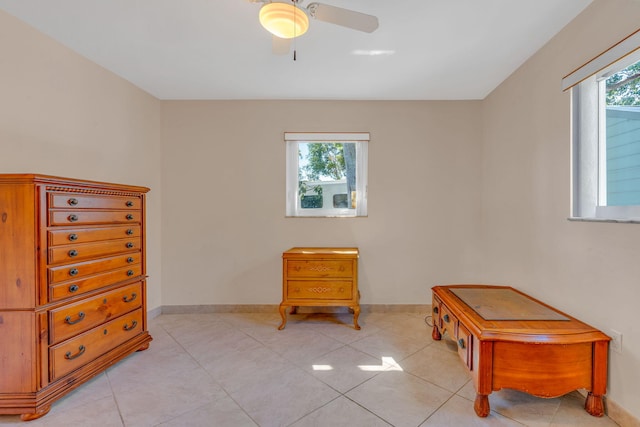 sitting room featuring light tile patterned flooring, plenty of natural light, and ceiling fan