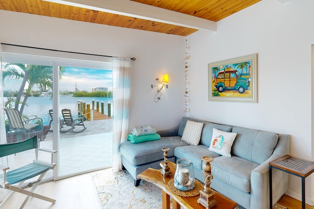 living room with a water view, light wood-type flooring, wooden ceiling, and beam ceiling