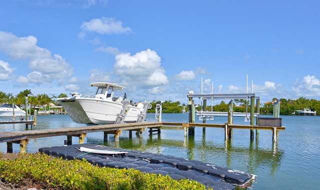 dock area with a water view and boat lift