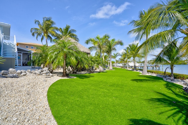 view of yard featuring a water view and a lanai